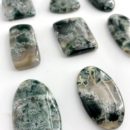 Angled Flat Lay of Tree Agate Pear Shape Top Drilled Cabochon Approx 35 - 40mm with 0.8mm Drill Hole 1
