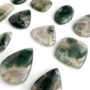 Angled Flat Lay of Moss Agate Mixed Shape Top Drilled Cabochons Approx 25 - 35mm with 0.8mm Drill Hole 2 Piece Pack