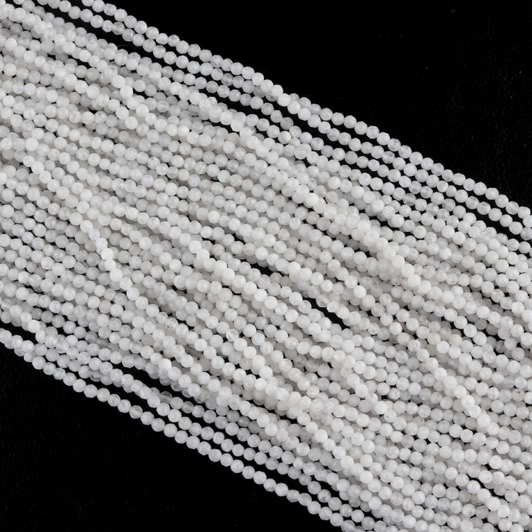 Angled Flat Lay of Multiple White Agate Micro Faceted Rounds Beads Approx 2mm 32cm Strands