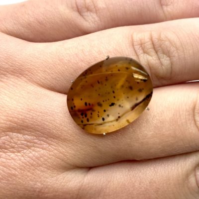 Montana Agate Cabochon in Prongs held against hand